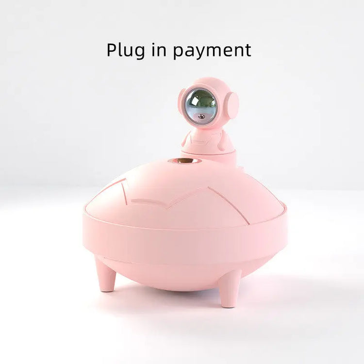 Rosa astronaut lampa luftfuktare med futuristisk design och liten astronautfigur på toppen